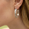 close up of sterling silver earrings with small black stones 