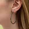 close up on model shot of Lluvia collection sterling silver earring with gold beading 42mm 