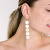 long silver dangle earring on model