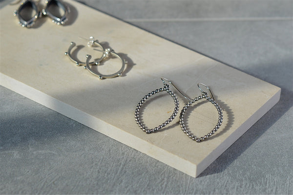 flat lay of sterling silver earrings