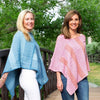 view of mananita ponchos, on left blue and light blue strip, and on right pink and orange 