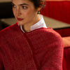 close up view of red poncho on model 