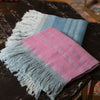 Close up photo of scarves - naturally dyed in indigo and cochineal. Fringe in Blue 
