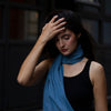 on model photo of brilliant blue indigo scarf around the neck 
