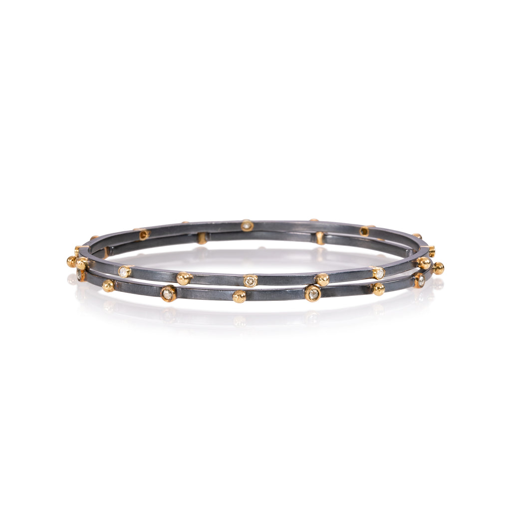 close up of diamond and gold bangles 
