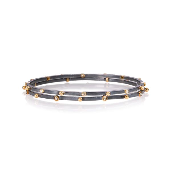 close up of diamond and gold bangles 