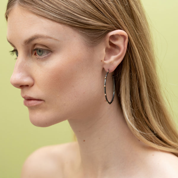 Sterling silver hoop earrings with gray patina and raised beading of 14k gold medium size 