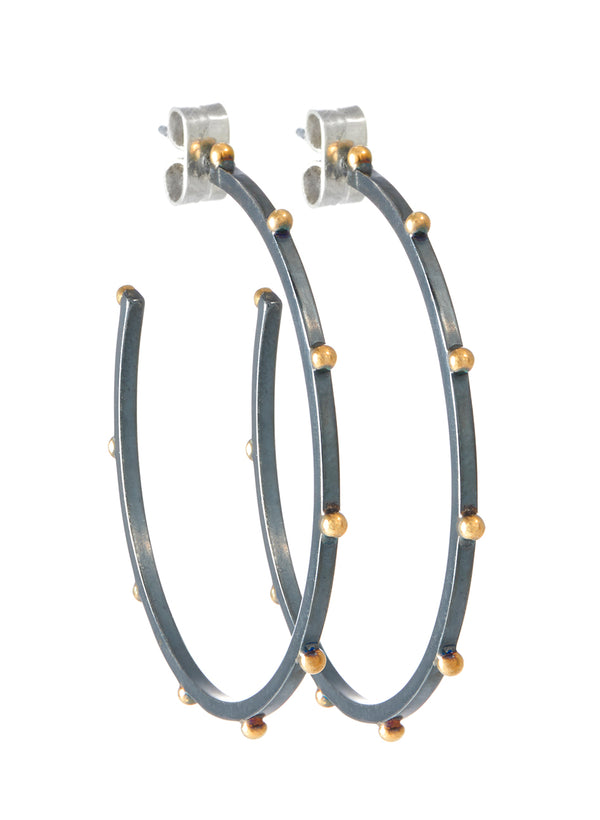 close up view of sterling silver Lluvia earrings with 14k gold stationed beading 