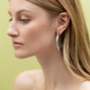 On model - hoop earring in sterling silver with beading in groups of three 