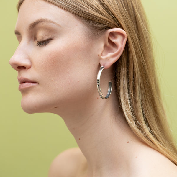 on model earring sterling silver hoop with beading in groups of three 