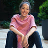 close up on model of cotton and wool pink and orange poncho with stripes 